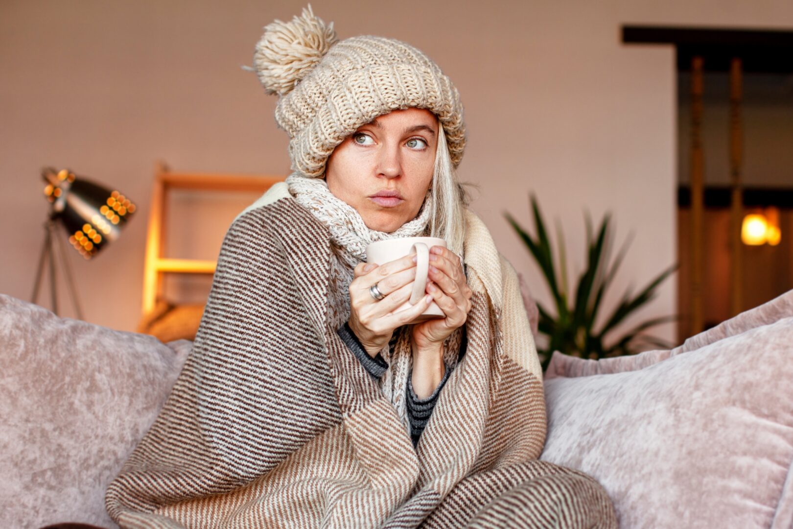 frozen-sadwomansitoncouchatfreezingcooledhouse
