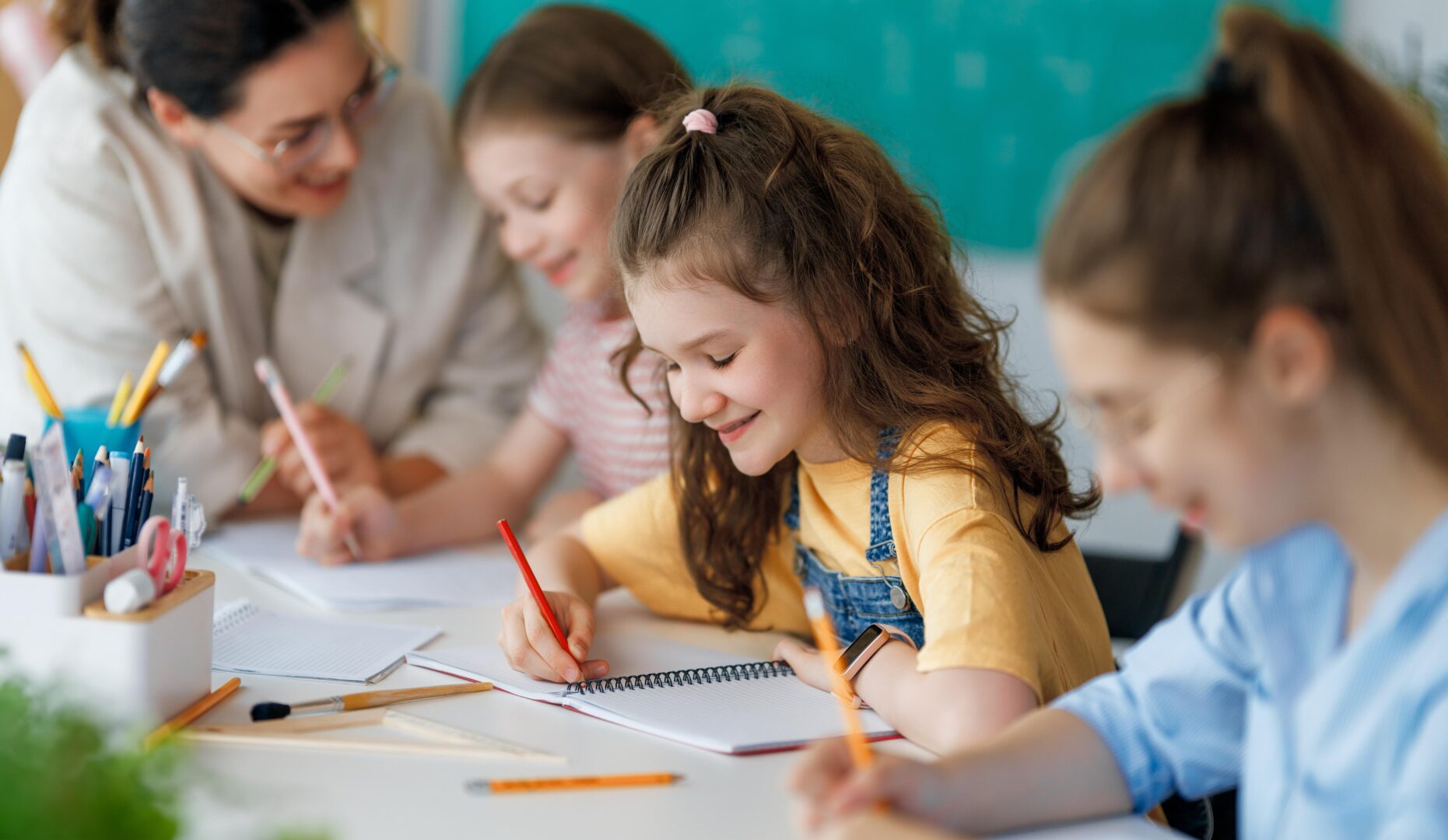 happykidsandteacheratschool-womanandchildrenare